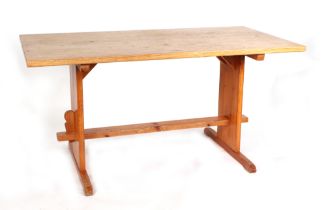 A modern pine refectory style table, having rectangular top, on style supports, joined by a