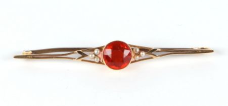 A 15ct gold bar brooch, set with a large dark orange central stone (possibly orange garnet), and six