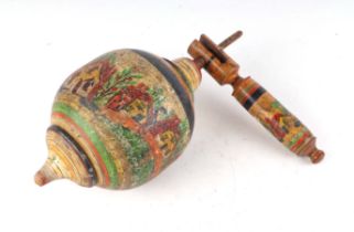 A turned wooden painted folk art spinning top, 32cm high.