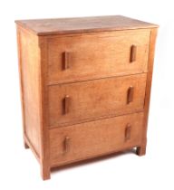 An early 20th century Heal's type oak chest with a lift-up rectangular top above a faux drawer