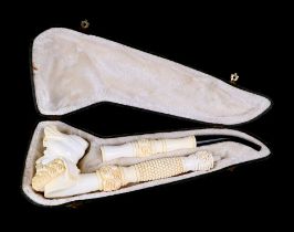A large two piece meerschaum pipe in the form of a bearded man, overall 42cm long, cased.