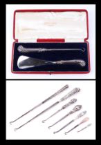 A boxed silver handled shoe horn and button hook set, together with a group of silver handled button