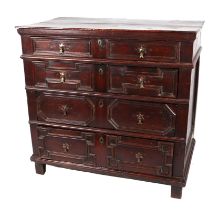 A late 17th century oak chest, having four graduated long drawers, each drawer having moulded