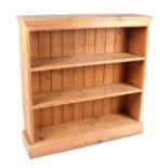 A pine open book case, on a plinth base, 31cm wide.