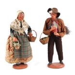 A pair of French terracotta Peddler dolls style figures, in traditional dress, each approx 30cm high