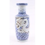 A Chinese blue and white vase, decorated in relief a scrolling dragon chasing a flaming pearl,