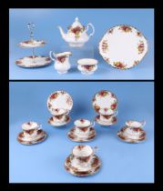 A Royal Albert Country Roses pattern tea set together with matching cake stand
