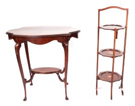 An Edwardian walnut two tier occasional table, crossbanded and having ebony and boxwood stringing,
