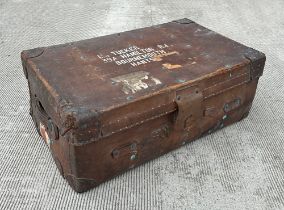 An early 20th century leather travel trunk, with reinforced corners, and a selection of paper