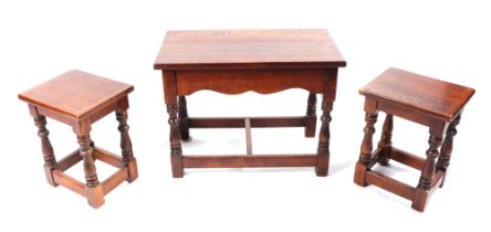 A nest of three oak 17th century style tables, largest 62cm wide (3).