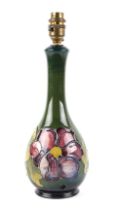 A Moorcroft pottery clematis pattern table lamp, 27cm high without fitting.