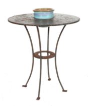 A well weathered painted metal garden table, with central hole holding a plant pot, 70cm diameter.