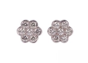 A pair of 18ct white gold diamond flowered stud earrings, each set with 7 brilliant cut diamonds,