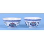 A pair of Chinese Wucai style tea bowls decorated with flowers, six character blue mark to the