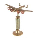 A trench art brass cast model of Wellington bomber, mounted on a brass plinth, wingspan 20cm.