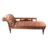 A Victorian upholstered chaise long, having carved show wood and turned legs.