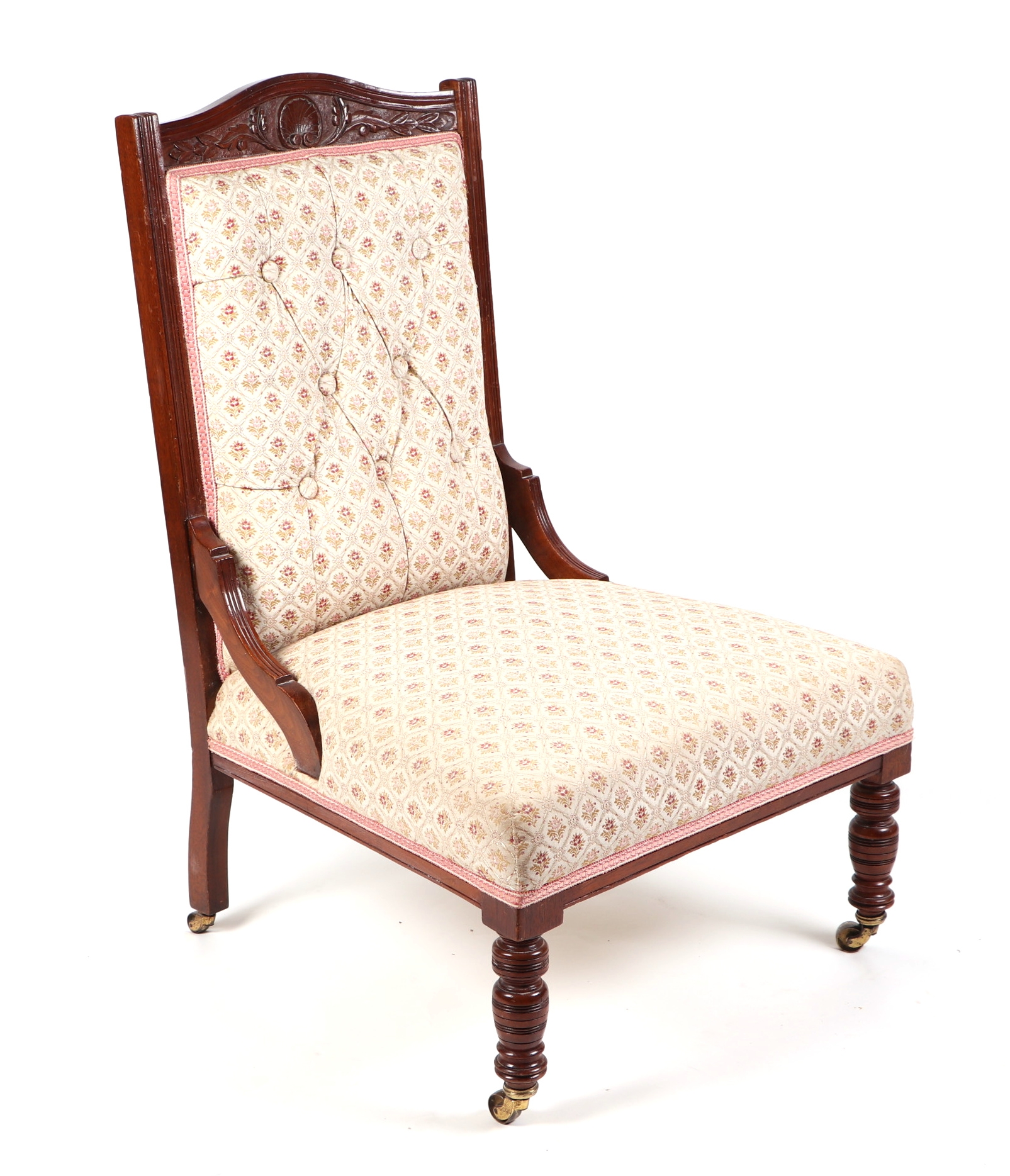 A late Victorian/Edwardian carved walnut upholstered nursing chair, with turned front legs.
