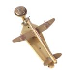 A trench art cast brass small aeroplane modelled as a door knocker, wingspan 10cm.