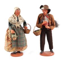 A pair of French terracotta Peddler dolls style figures, in traditional dress, each approx 30cm high