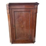 A 19th century mahogany hanging corner cabinet, having field panel door enclosing shelves, 86cm