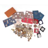 A quantity of mixed UK and foreign coinage to include proof sets.