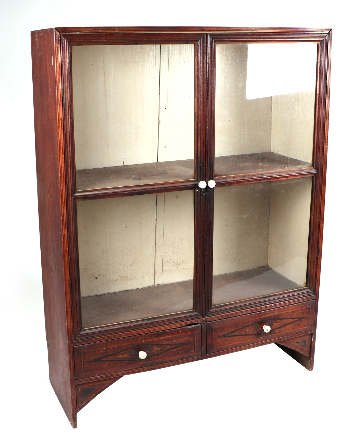 A teak display cabinet, having twin glazed doors enclosing shelves, above a drawer, 86cm wide.