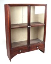 A teak display cabinet, having twin glazed doors enclosing shelves, above a drawer, 86cm wide.