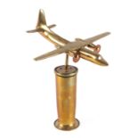 A cast brass model of a twin engine aircraft, mounted on a brass plinth, wingspan 17cm.