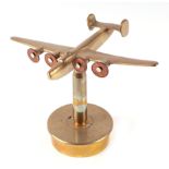 A trench art cast brass model of Wellington Bomber, mounted on a brass shell case, wingspan 22cm.