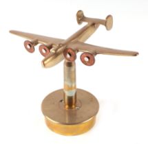 A trench art cast brass model of Wellington Bomber, mounted on a brass shell case, wingspan 22cm.