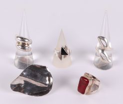 Five silver Modernist style rings. Condition Report The largest surfaced ring is a size P, the red
