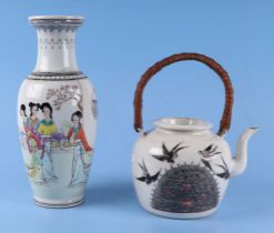 A Chinese famille rose teapot, decorated butterflies, swallows and flowers, and having a red seal