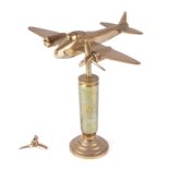 A trench art cast brass model of Mosquito aircraft, mounted on a brass plinth, wingspan 20cm.