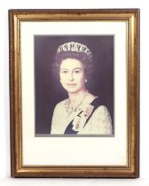 A photographic print of Her Majesty Queen Elizabeth II, 40 by 50cm, framed and glazed.