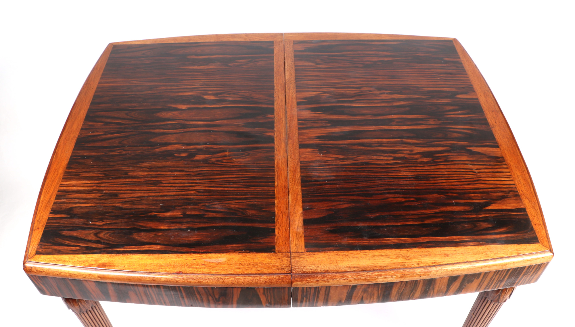 A 1920s Art Deco coromandel dining table, having a rectangular top inset, one extra leaf, on - Image 2 of 4