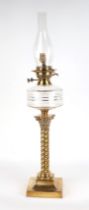 A Victorian brass and glass oil lamp, on on Corinthian column, 58cm high with fittings.