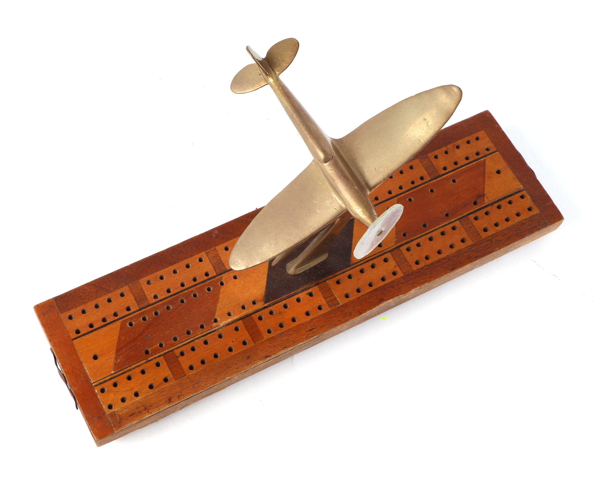A trench art cast brass model of a Spitfire aircraft, mounted on a cribbage board, wingspan 13cm. - Image 2 of 2