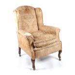 A Victorian upholstered wingback armchair, together with a Lloyd Loom style painted wicker chair (