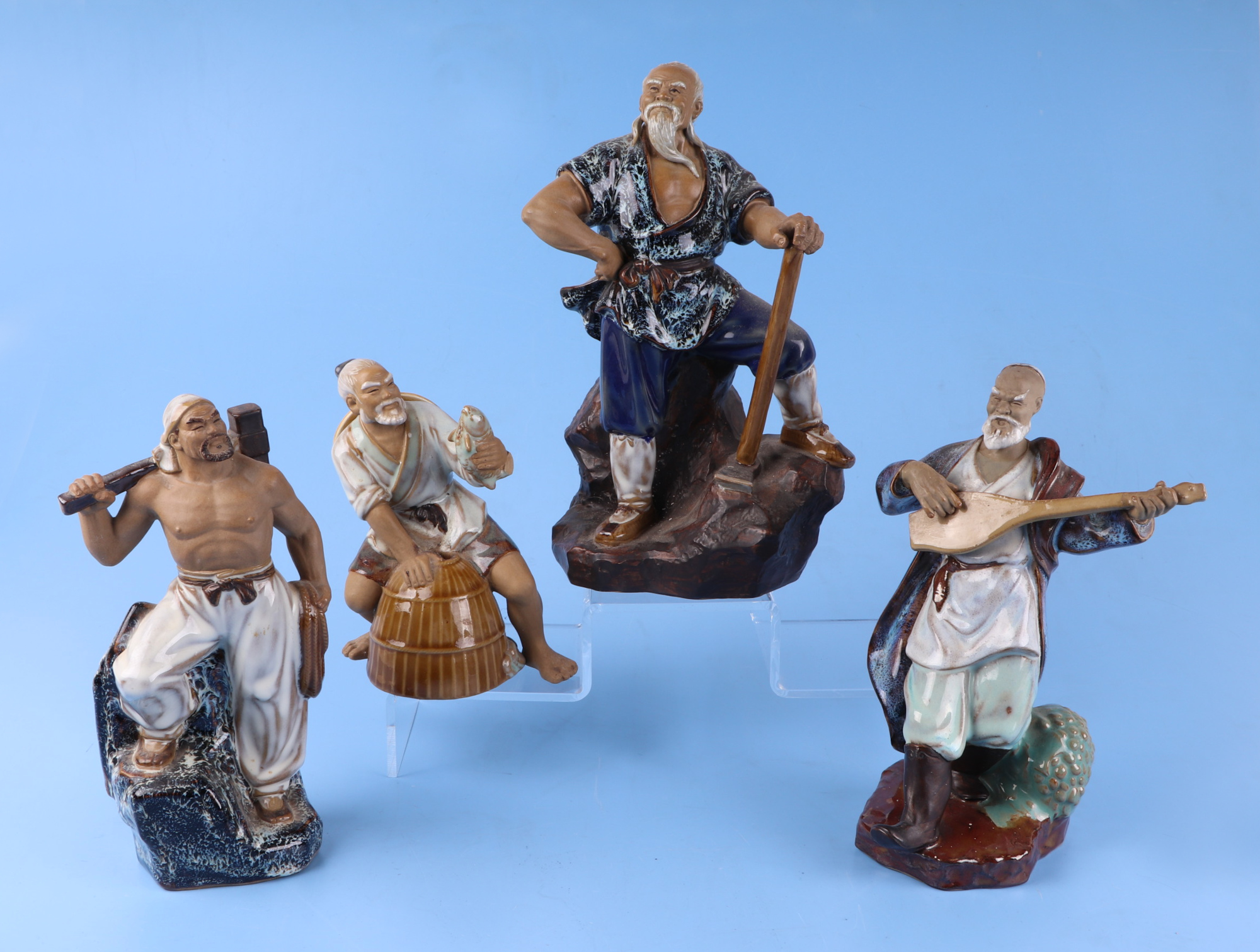 A group of glazed Chinese pottery figures, largest 26cm high (8).