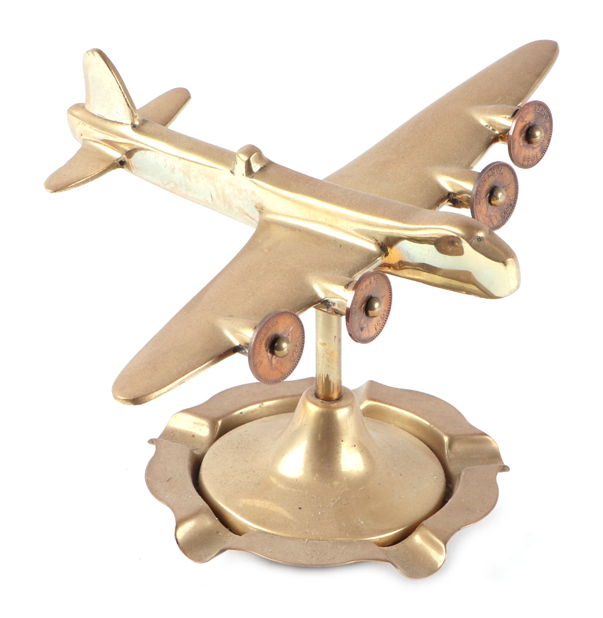A trench art cast brass model of a Sterling bomber, on a brass ashtray, wingspan 19cm.