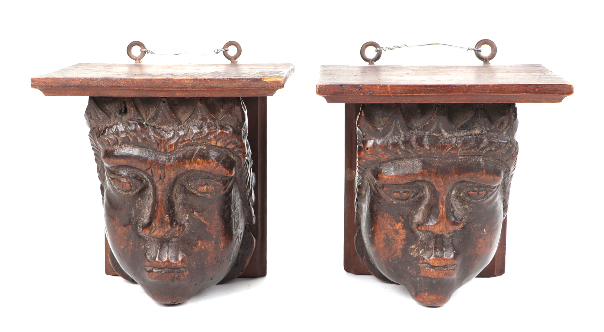 A pair of carved fruit wood corbels, in the form of a King and Queen, possible medieval, each 14cm