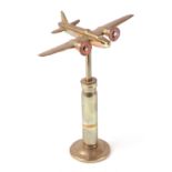 A trench art cast brass model of a Wellington bomber, mounted on a brass plinth, wingspan 17cm.