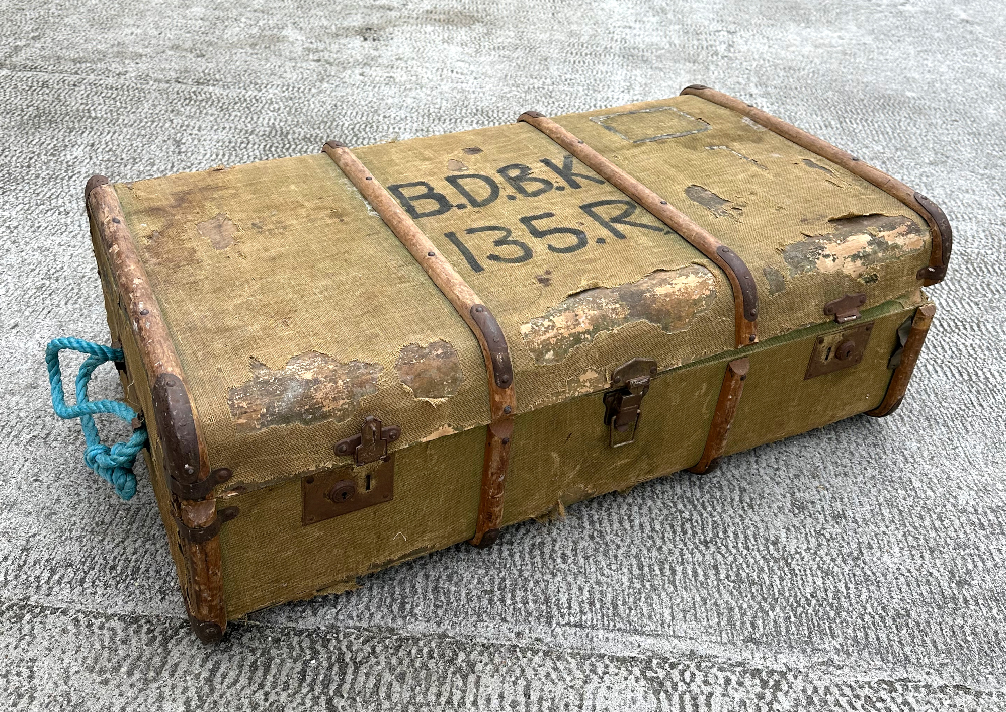 A wooden bound canvas travel trunk, 90cm wide.