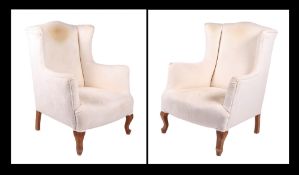 A pair of George III style wingback upholstered armchairs on cabriole front legs (2). Condition