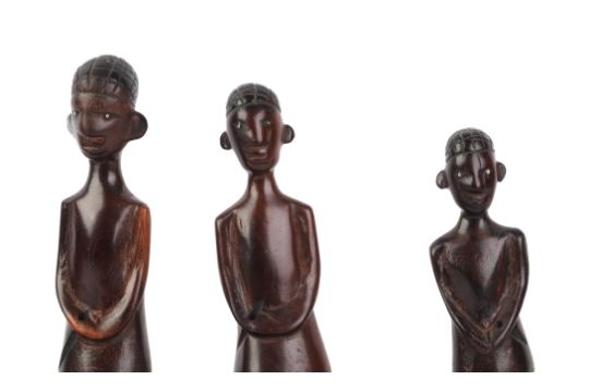 An African hardwood carved figural group depicting a canoe and five figures, 70cms long. - Image 2 of 4