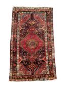 A Persian Nahavand hand knotted rug, the central medallion framed by stylised floral designs and