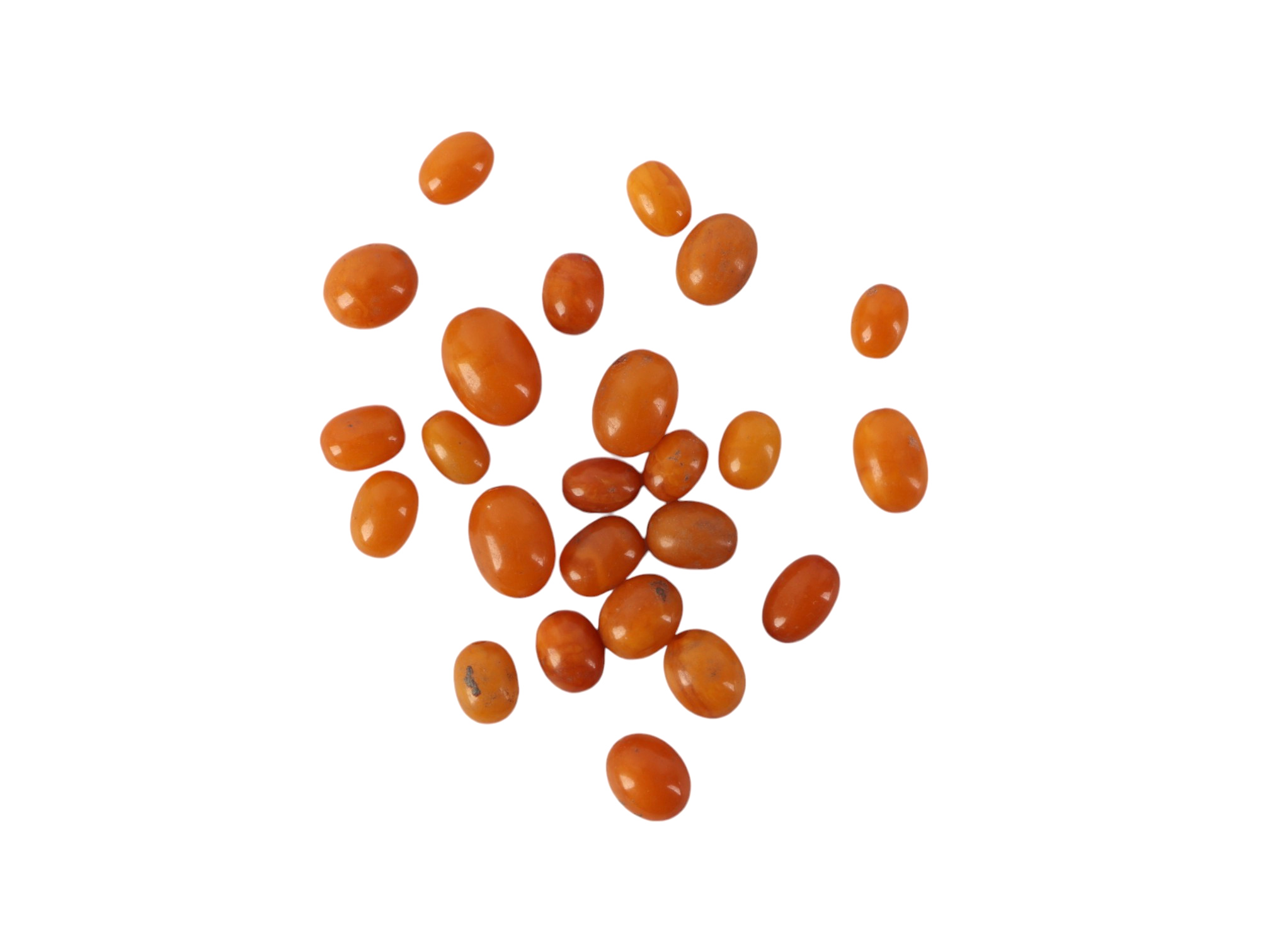 A group of twenty four butterscotch amber beads, the largest bead 17mm, 23g.