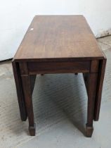 An oak drop leaf table, on four tapering legs and