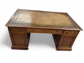 A 19th century mahogany veneer partners desk, the