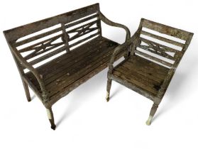 A wooden garden bench, with decorative back and sh